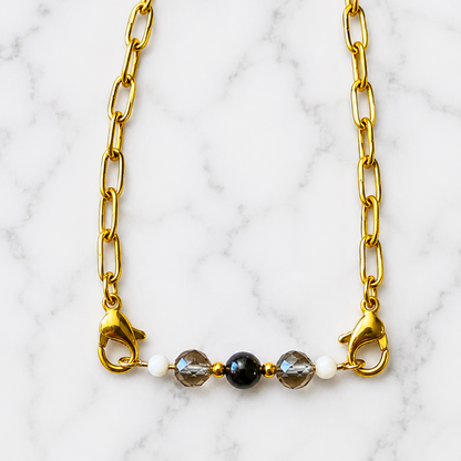 Remove Negative Energy Intention Bracelet with black obsidian and smoky quartz on white marble