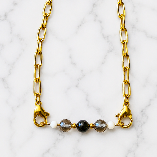 Remove Negative Energy Intention Bracelet with black obsidian and smoky quartz on white marble